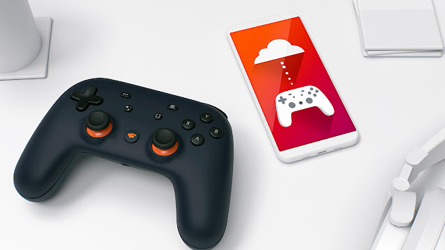 Photograph of a Stadia video game controller and a phone connecting the controller to cloud gaming