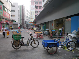 tricycle cart, electric bicycle, and woman walking with a little girl