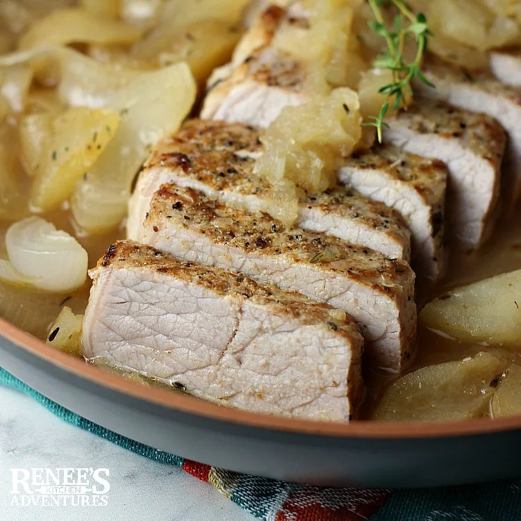 Pork Loin Filet with Apples and Onions by Renee's Kitchen Adventures sliced pork in pan with apples and onions ready to eat, overhead shot