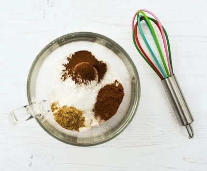 gingerbread spices in glass mug of cake mix