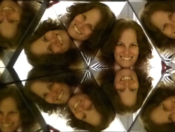 My smiling face, multiplied several times within a giant kaleidoscope.