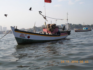 A small motorized boat named "Sacred Heart".