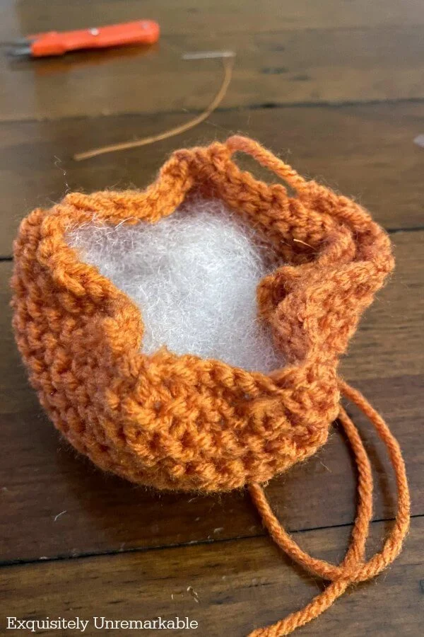 Stuffing A Yarn Pumpkin with polyfil