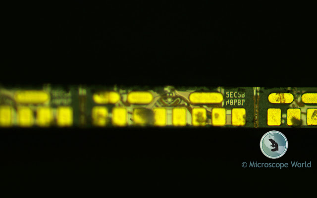 Metallurgical microscope image of a circuit captured at 100x magnification showing high quality resolution.