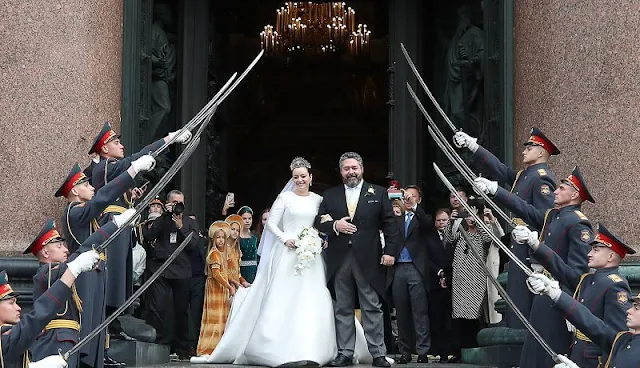 The bride Victoria Romanovna Bettarini wore a white satin gown by fashion designer Reem Acra, and the Lacis Tiara by Chaumet