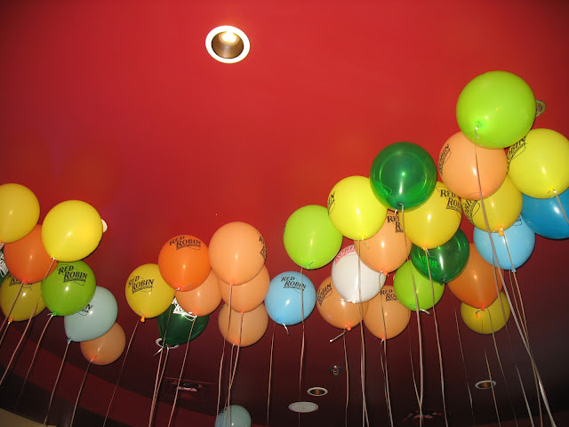 The ceiling inside of Red Robin is filled with balloons