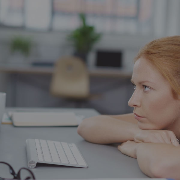 frustrated woman looking at computer screen