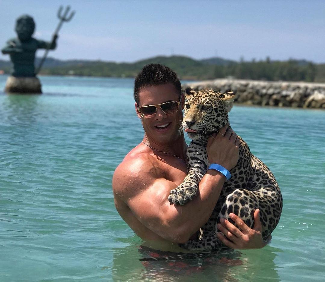 sexy-muscle-daddy-sunglasses-swimming-sea-holding-young-leopard-animal-logan-franklin