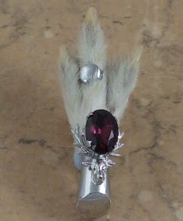 Grouse foot brooch with a purple rhinestone
