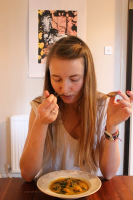 Melissa eating a bowl of Sweet Potato, Peanut and Chilli Stew