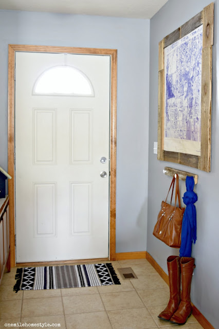 DIY a simple farmhouse entryway with a reclaimed wood organizer, and large statement art to add a personal touch to the space.