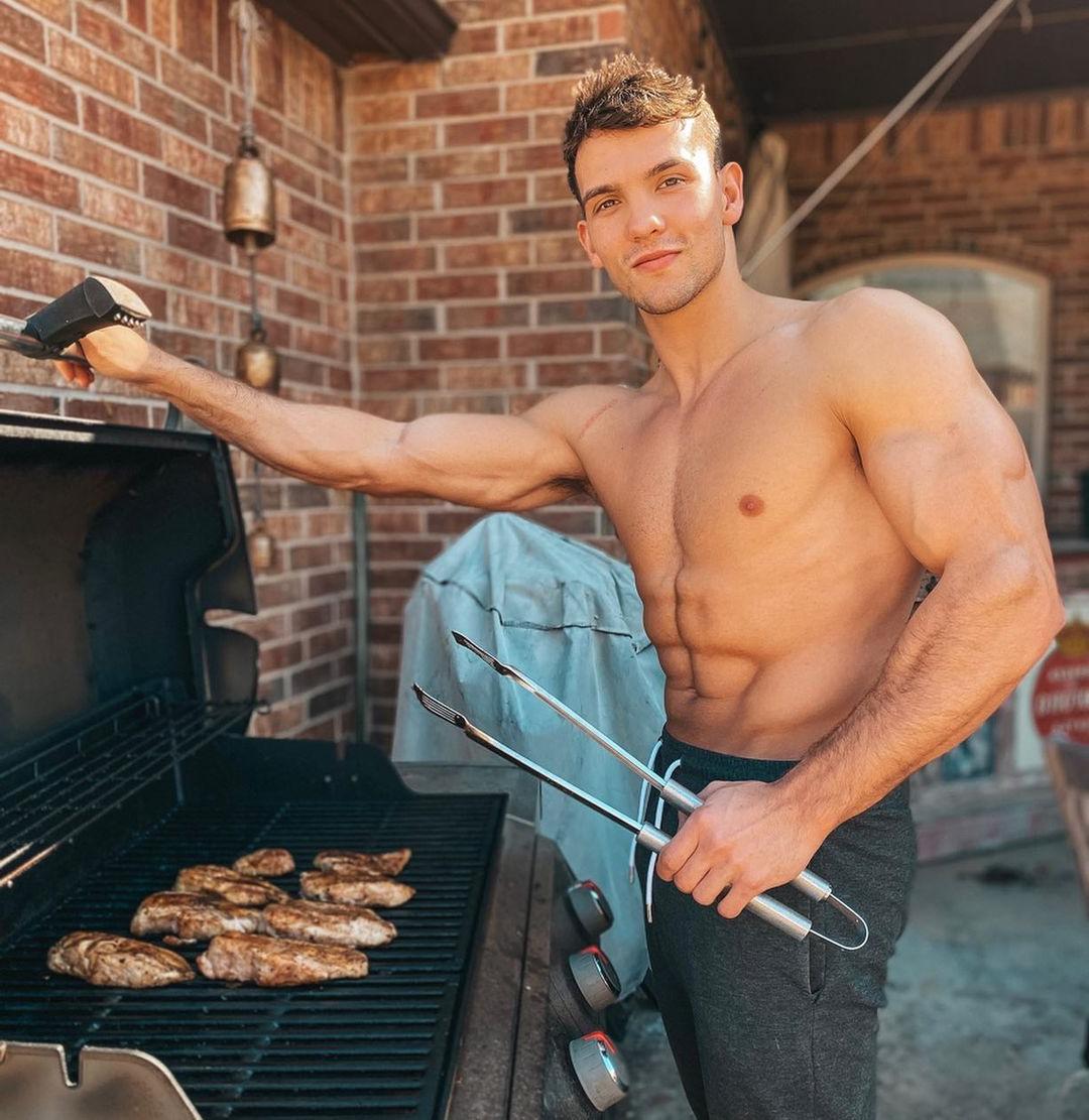 shirtless-fit-cute-guy-grilling-meat-outdoors