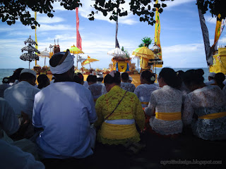 Villagers Sitting Together In Front Of Pratima Symbol Of God During Melasti Ceremonial Before Nyepi Day On The Beach