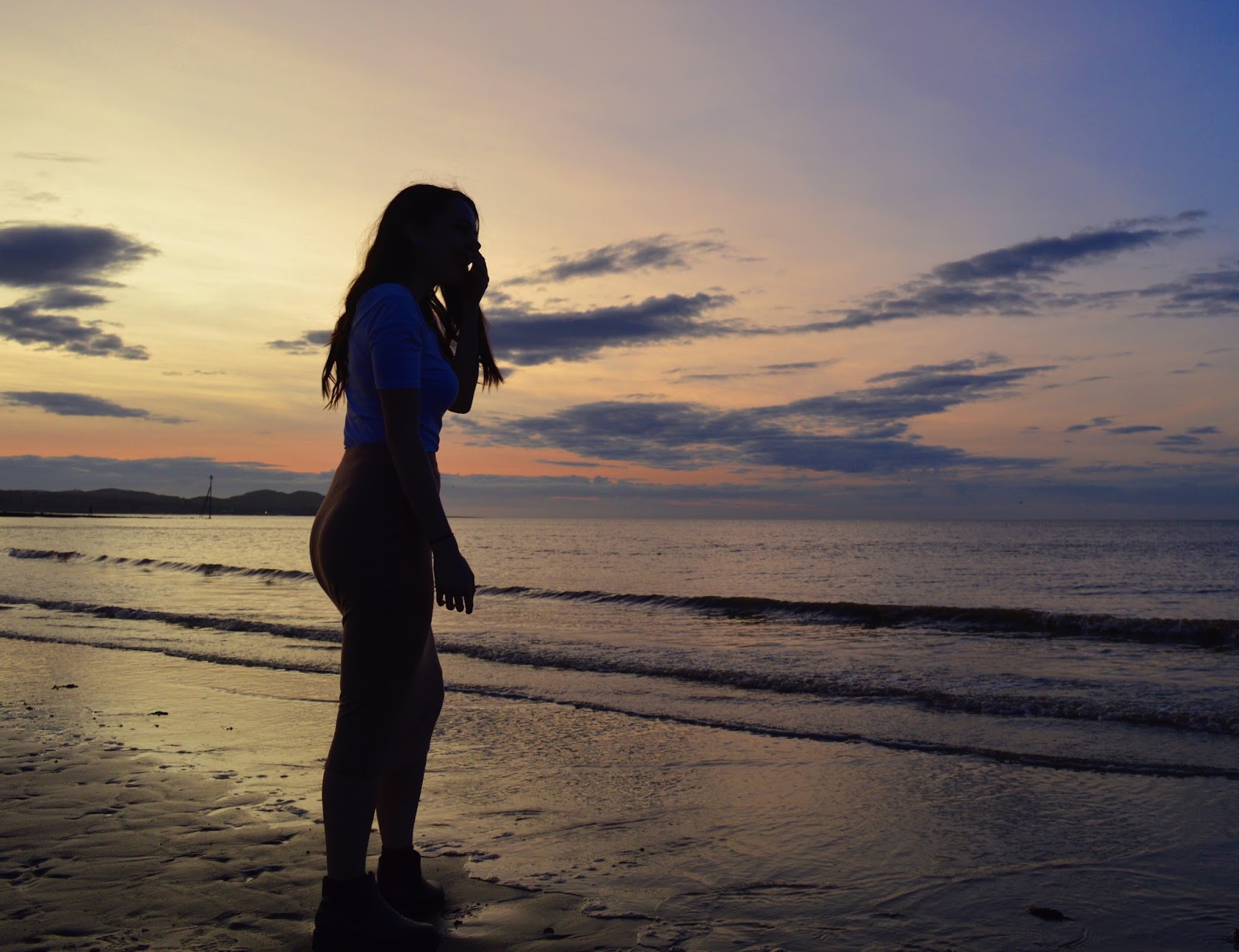 girl in front of sunset, wales
