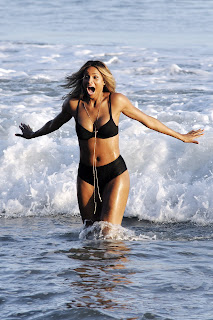 Ciara splashing in the water and wearing a hot two piece bikini