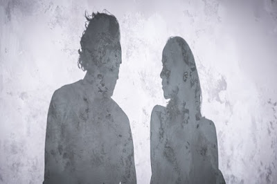 Shadows of a man and woman, looking at each other