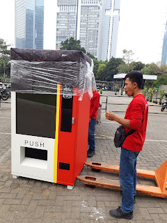 Mover lifting a box in an office