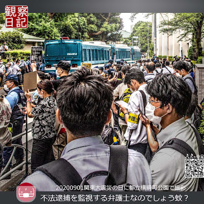 ２０２０年９月１日。関東大震災の日。都立横綱町公園でそよ風と言う団体とそのカウンターの人たちが集まる中で弁護士の腕章をする人がいた。機動隊のバスが写り警察官も沢山いる中で弁護士の腕章が光っていた。そんな場面を写した写真です。