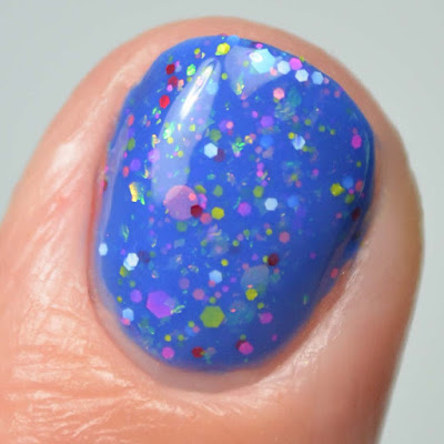 blue nail polish with glitter close up swatch