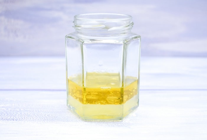 making salad dressing in a jam jar Oli and lemon juice in a jam jar