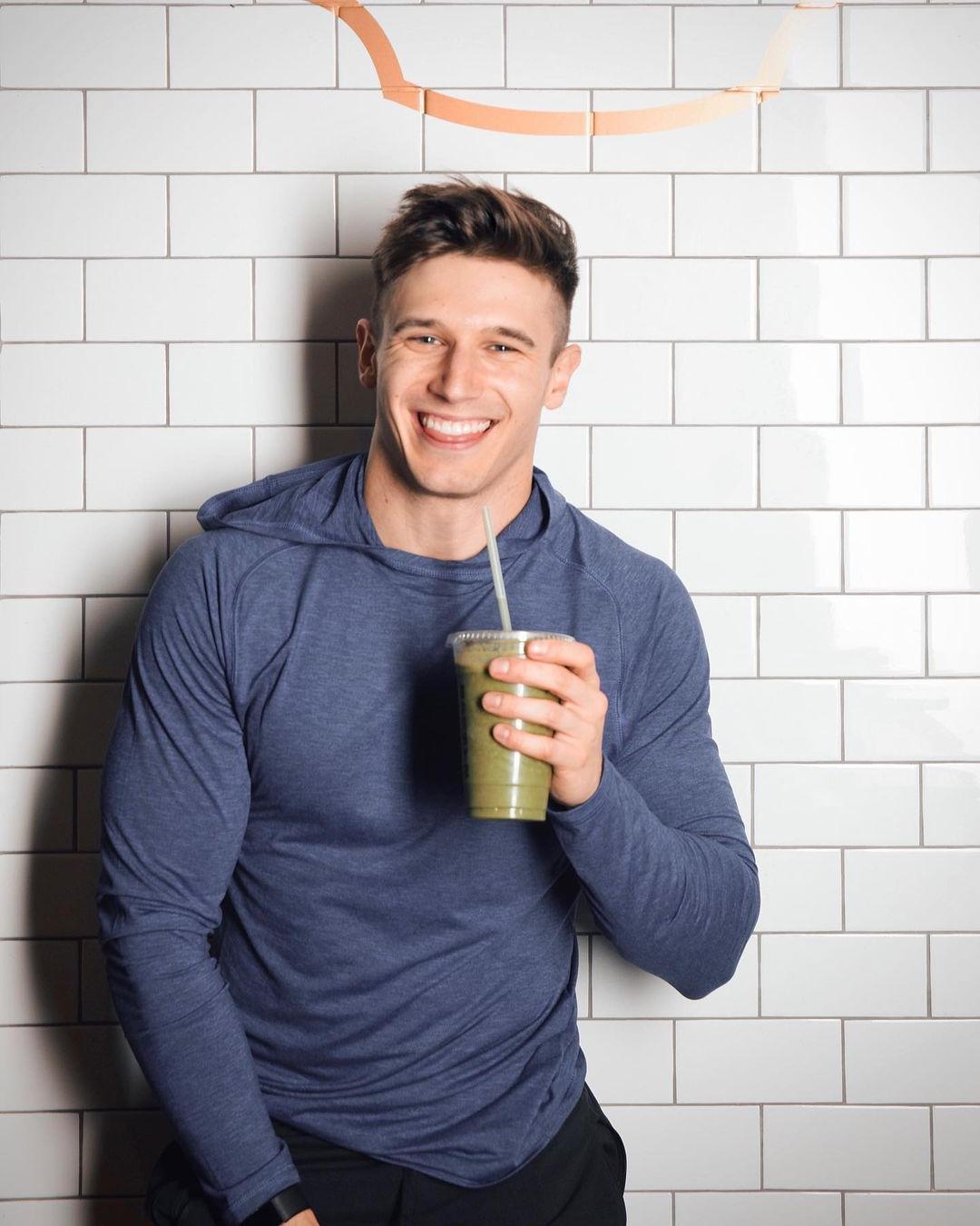cute-fit-gay-guy-smiling-drinking-green-smoothie