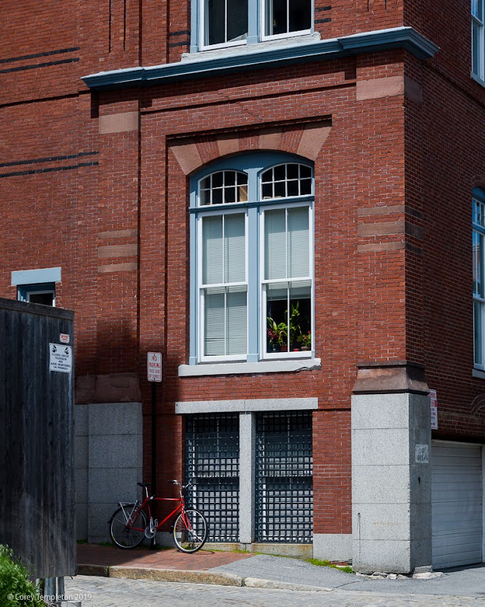 Portland, Maine USA May 2019 photo by Corey Templeton. Red bike and red bricks on Silver Street.