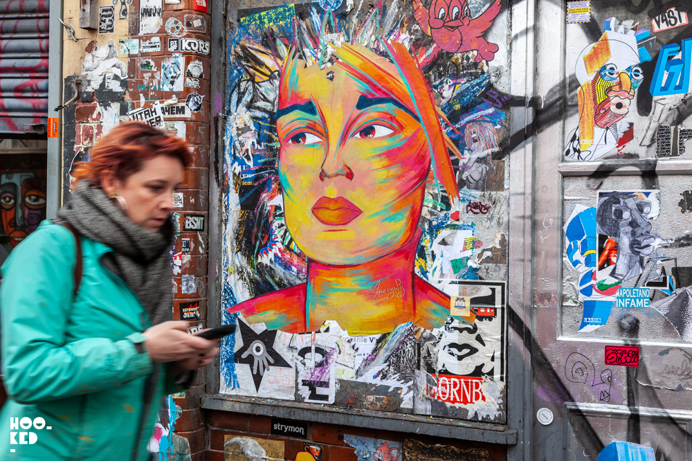 French Street Artist Manyoly in London with female portrait pasteups