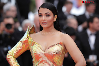 Aishwarya Rai in a Shoulder less Sleeveless Deep neck Golden Gown at A Hidden Life Screening Cannes