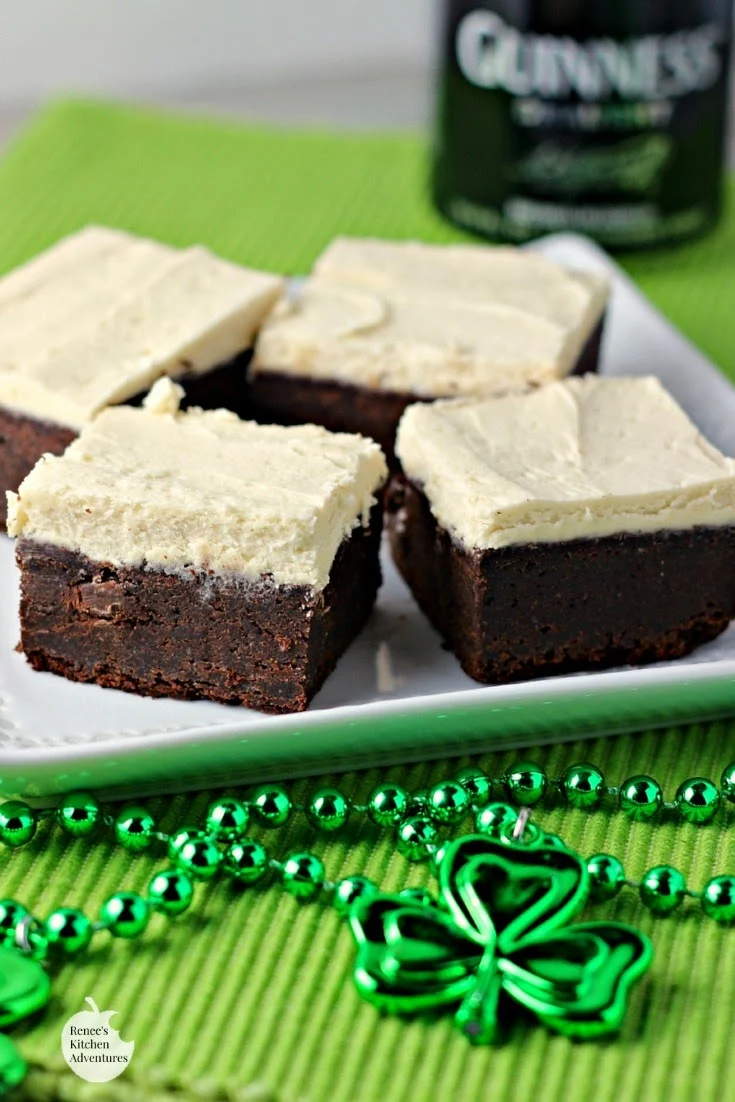 Guinness Brownies with Maple Buttercream Frosting on a white plate vertical image