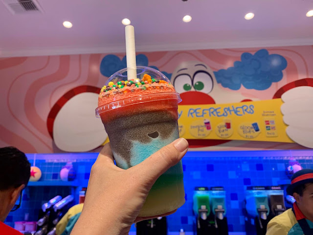 Rainbow Slush at Bing Bongs Sweet Stuff at Disneyland best disneyland food, pickles, mango, lamplight lounge, rising moons overnight pineapple juice radiator springs racers mint julep bar pixar pier, park ticket, cars land, healthy food at disneyland disneyland california food disneyland california tips disneyland food guide 2019 disneyland food guide 2020 disneyland food must haves disney food blog disneyland food to eat in disneyland can you bring food into disneyland 10 best foods at disneyland *where is dole whip in disneyland dole whip disneland mobile order disneyland dole whip locations disney mickey rice krispie treats must have snacks at disneyland disney snack food snacks disneyland : lobster nachos disneyland park disneyland resort mint julep bar cafe orleans lamplight lounge cozy cone motel harbour galley cars land disney california adventure park eat at disneyland blue bayou bengal barbecue orleans square dole whips corn dog castle plaza inn carthay circle restaurant, bread bowls bing bong s sweet, carnation cafe, guardians of the galaxy, bengal barbecue, pickling cucumbers, plaza inn, moons overnight oats, docking bay 7 food, ice creams, dole whip, bao, num num cookies, rising moons overnight oats, rainbow unicorn, bing bong sweet stuff, disneyland california, california adventure, los angeles, disney world,