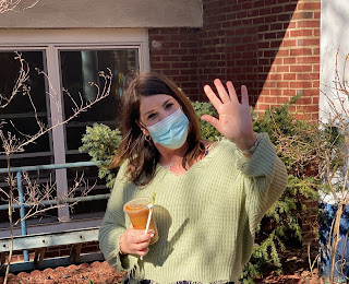 Kristen Ahfeld waves for the camera in the courtyard of the Garden School in Jackson Heights, Queens