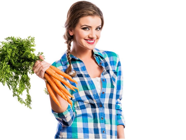 Health benefits of Carrots  - Women eating Carrots