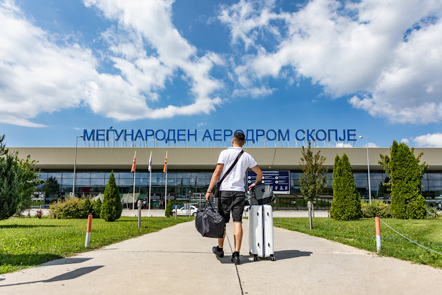 Person walking up to Skopje Airport terminal