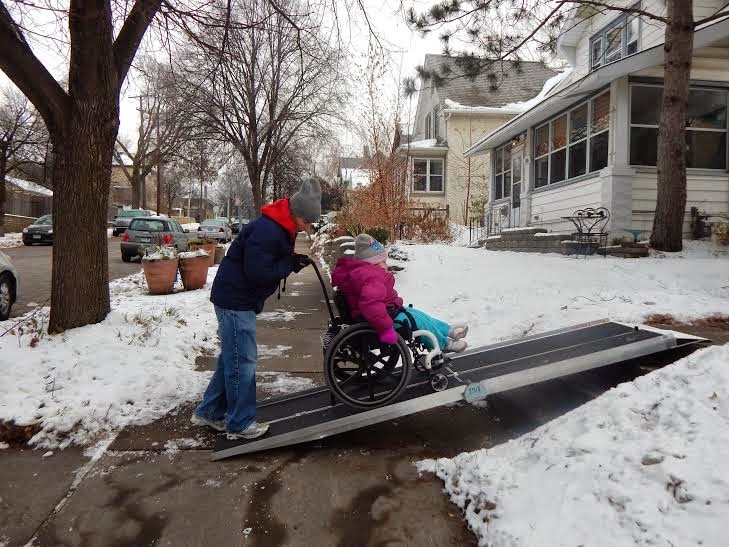 Wheelchair ramps promote safety. Wheelchair ramp being used in winter by elderly people.