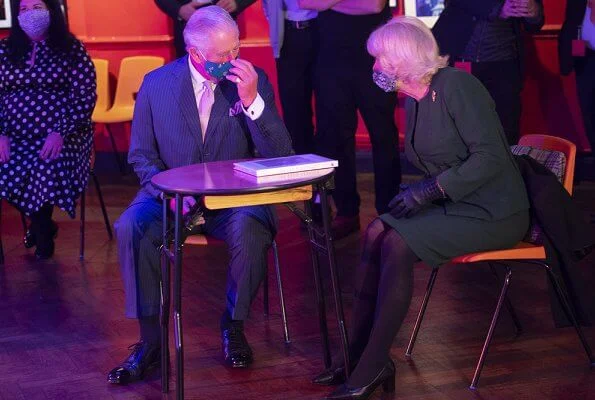 The Duchess of Cornwall wore a green skirt suit and black cape