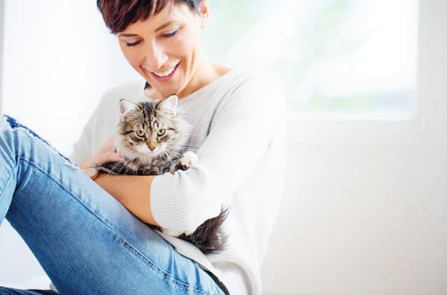 woman holding cat