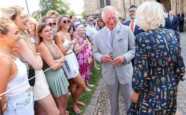 Charles wearing a crisp grey suit and Camilla wore her favourite dress by Fiona Clare