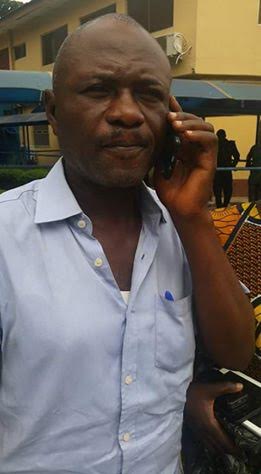 Lekan Shonde making a call at the Police station after his arrest