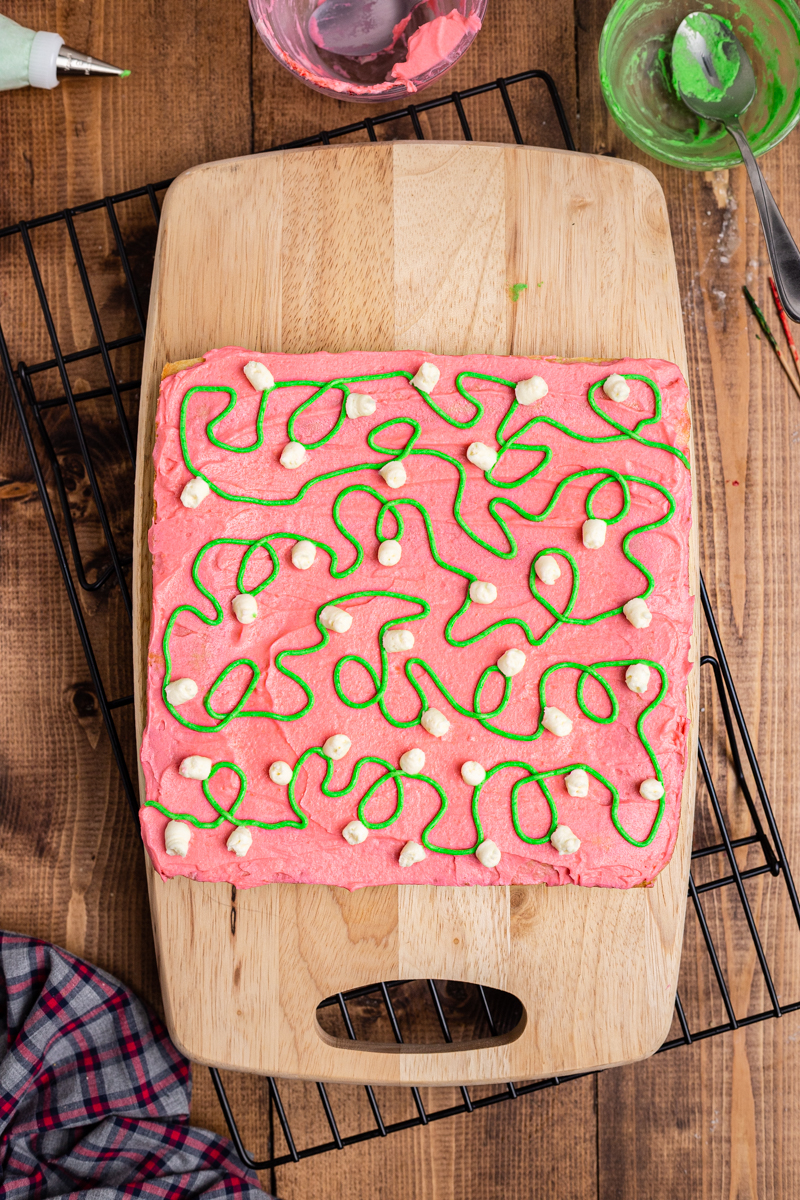 Overhead photo of Keto Sugar Cookie Bars decorated with red, green, and white frosting to look like Christmas lights.