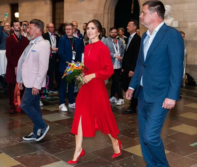 Crown Princess Mary wore an Armonia red silk georgette dress by Raquel Diniz. Gianvito Rossi. Rebekka Notkin carved gold earrings