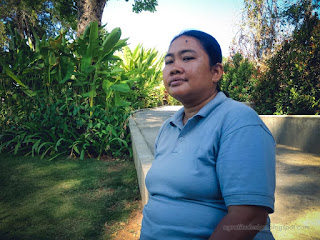 Woman Traveler Enjoy A Holiday Sitting On The Edge Of The Walkway Of The Tropical Garden On A Sunny Day North Bali Indonesia