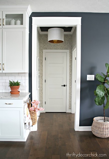 blue and white wallpaper in hallway white door