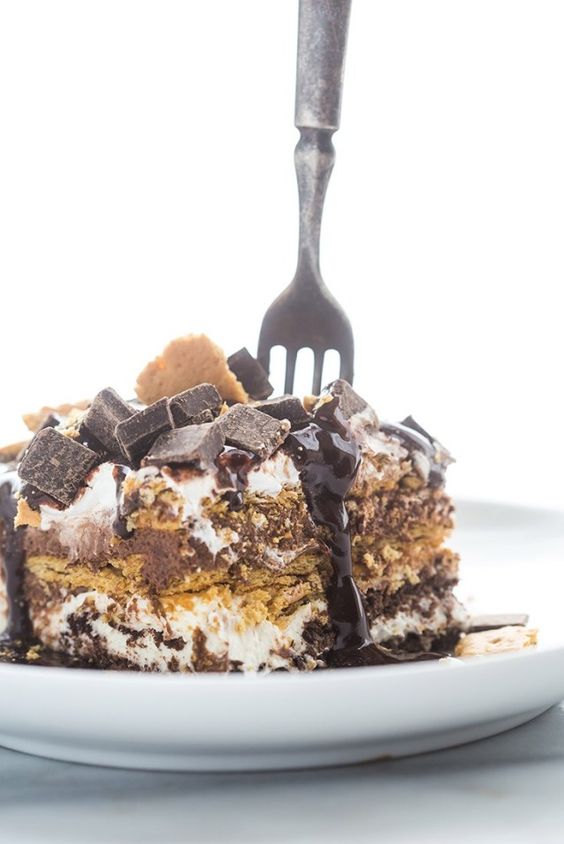 This dessert doesn't just feed a crowd, it treats a crowd! If you're looking for a real crowd-pleaser, this sweet s'mores inspired overnight cake is about to become a favorite
