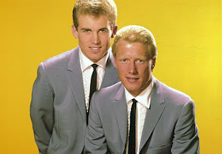 Jan and Dean color publicity photo yellow background gray suits and tie