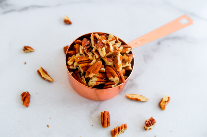 pecans in copper measuring cup