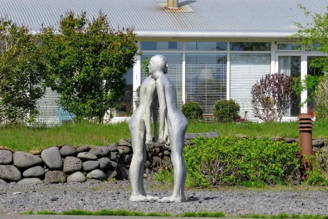 Two silver modern art statues hugging in Seltjarnarnes Iceland