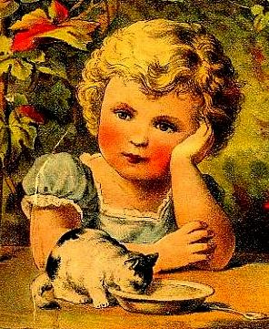Little blond girl in blue dress leaning on table while black and white kitten laps bowl of milk in foreground.