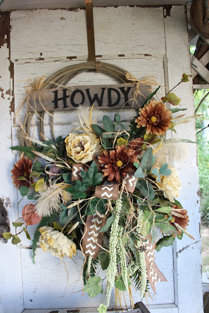 rustic lasso wreath with tan and cream flowers