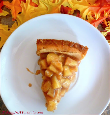 Celebrate apple season with an Apple Pie Cheesecake, apple pie flavored cheesecake with a caramel apple topping. | Recipe developed by www.BakingInATornado.com | #recipe #apple #RoshHashanah