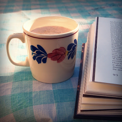 A half read book and a hot cup of coffee